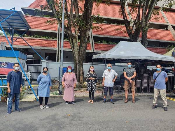 Hannah (tengah) bersama beberapa ahli jawatankuasa Persatuan Kebajikan Penjaja Dan Peniaga Kecil Pasar Besar TTDI sewaktu turun padang di pasar berkenaan pada Sabtu.