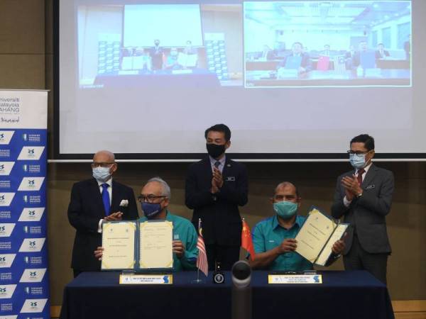 Mohd Khairul Adib (berdiri, tengah) menyaksikan majlis menandatangani Perjanjian Persefahaman (MOU) Program Dual Ijazah Universiti Malaysia Pahang (UMP) dan Beijing Jiaotong Universitiy, China hari ini. - Foto Bernama