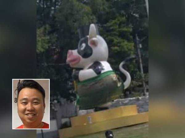 Dekorasi replika lembu yang memakai songkok dan samping di Bulatan Jalan Air Itam, Georgetown yang menimbulkan kemarahan orang ramai terutamanya umat Islam. Gambar kecil: Joseph Ng