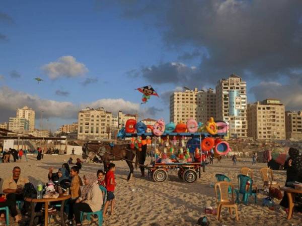 Penduduk Palestin beriadah di tepi pantai di Bandar Gaza selepas konflik Israel-Palestin berlarutan selama 11 hari berakhir pada Jumaat lalu. - Foto: AFP