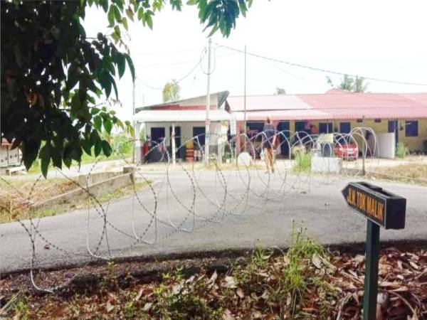 Pemasangan kawad berduri di PKPD Kutan Tengah bagi mengelakkan penduduk di kawasan tersebut meloloskan diri. -Foto Wan Ahmad Jauzi