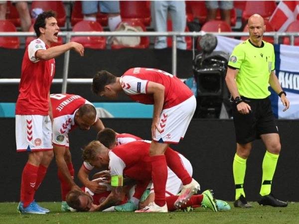 Pemain Denmark memberi pertolongan kecemasan segera kepada Eriksen selepas pemain tersebut rebah semasa aksi Kumpulan B Euro 2020 Denmark menentang Finland di Stadium Parken, Copenhagen. - Foto AFP