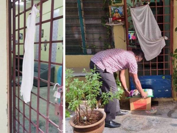 Arul Kumar meletakkan barangan keperluan di luar pintu rumah penduduk yang mengibarkan bendera putih.