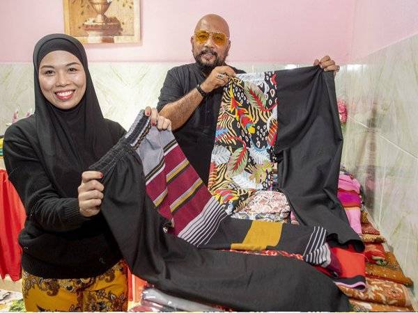 Mohd Rosoliza bersama isteri Zarina menunjukkan seluar 'Separuh Rindu' yang ditempah oleh pelanggannya ketika ditemui Bernama di rumahnya di Kubang Kerian hari ini.