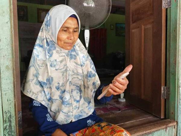 Fatimah melepaskan rindu kepada anak-anak dan cucu dengan berbual menerusi panggilan video dari rumahnya di Kuala Krai.