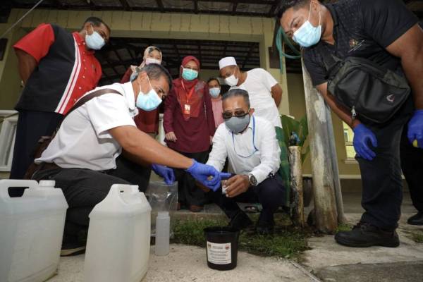 Pegawai Kesihatan Daerah Kota Bharu, Dr Izamin Idris (dua dari kanan) melakukan proses melepaskan telur aedes wolbachia ke kawasan Pondok Pasir Tumboh, Kota Bharu pada Ahad.