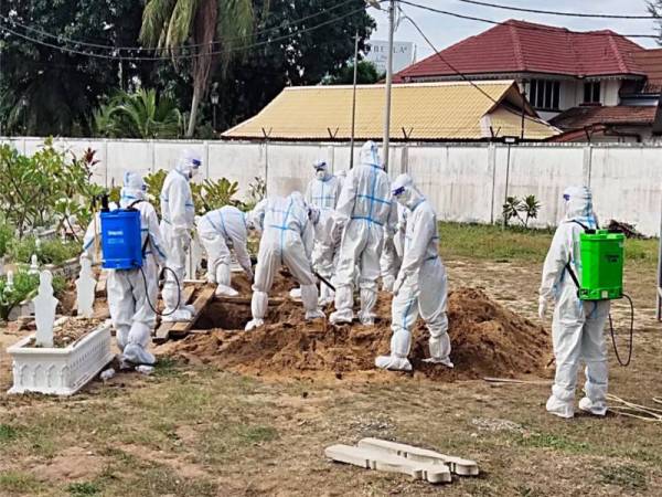 Anggota JBPM Terengganu sedang menguruskan pengebumian salah seorang mangsa Covid-19 di Tanah Perkuburan Kampung Batu Buruk, Kuala Terengganu Foto: ihsan JBPM Terengganu