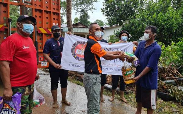 Pelajar terjejas menerima sumbangan barangan keperluan dari ResQ Team UPSI yang berkunjung ke lokasi terjejas di daerah Kuala Muda dan Yan.