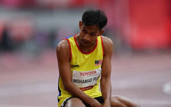 Mohamad Ridzuan beraksi dalam acara 100m T36 lelaki pada temasya Sukan Paralimpik Tokyo 2020 di Stadium Olimpik pada Sabtu. - Foto Bernama