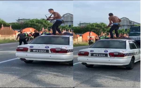 Tangkap layar video lelaki memanjat kereta polis sambil mengayunkan sabit dan parang di Gopeng. Foto: Ihsan pembaca