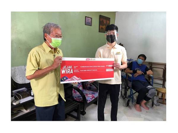 
Yam Seng menerima sumbangan RM2,000 daripada Rayeon Lee yang mewakili LBS Bina Group untuk program Jejak Wira.