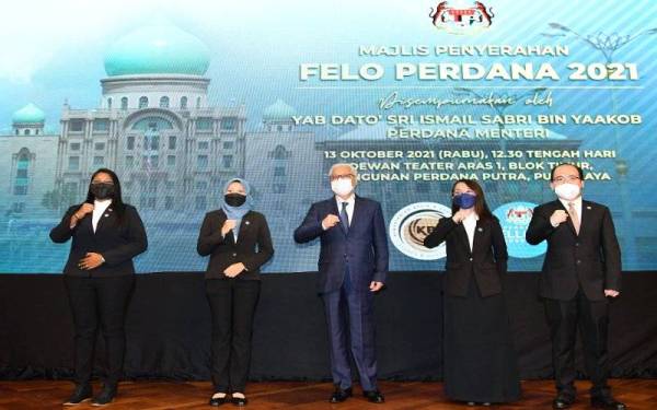 Ismail Sabri (tengah) bergambar kenangan bersama Felo Perdana kepada Perdana Menteri pada majlis penyerahan Felo Perdana kepada ahli jemaah menteri bagi tahun ini di Perdana Putra hari ini. Foto Bernama