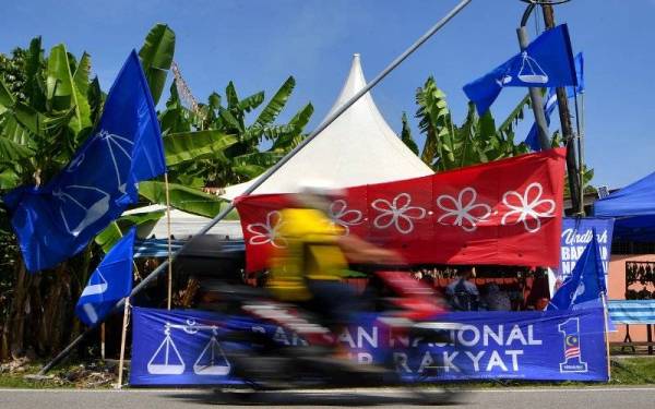 Bendera BN dan Bersatu mula dipasang menjelang penamaan calon bagi PRN Melaka hari ini ketika di sekitar Dewan Undangan Negeri Tanjung Bidara. Foto Bernama