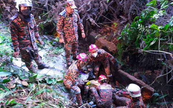 Pasukan bomba menjalankan operasi mengeluarkan mangsa di Jalan Simpang Pulai-Blue Valley, Simpang Pulai pada Khamis. - Foto ihsan Bomba Perak.