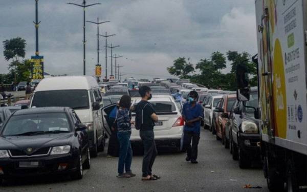 Pengguna jalan raya di Persiaran Tuanku Ampuan, Shah Alam masih menunggu banjir surut bagi meneruskan perjalanan mereka ekoran tersangkut akibat banjir kilat yang melanda di beberapa tempat sekitar Lembah Klang sejak Sabtu. - Foto Bernama