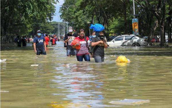 Mangsa-mangsa banjir mengambil barang keperluan berikutan banjir yang masih belum surut sepenuhnya pada Selasa. - Foto Bernama 