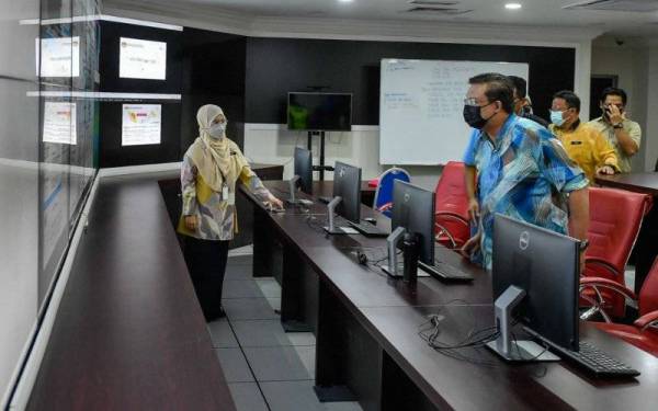 Ketua Setiausaha Negara Tan Sri Mohd Zuki Ali melihat skrin sistem ramalan dan amaran banjir pada Lawatan Kerja Ketua Setiausaha Negara dan Ketua Setiausaha Kementerian Alam Sekitar dan Air ke Pusat Ramalan dan Amaran Banjir Negara (PRABN) di Jabatan Pengairan dan Saliran Malaysia, Jalan Ampang hari ini. - Foto Bernama