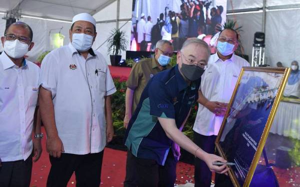 Menteri Pengangkutan Datuk Seri Dr Wee Ka Siong menurunkan tandatangan pada gambar pelan projek pembesaran Pelabuhan Kemaman di Dermaga Timur Pelabuhan Kemaman hari ini. Foto - Bernama