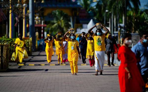 Orang ramai khususnya penganut Hindu mematuhi SOP seperti pemakaian pelitup separuh muka, pemeriksaan suhu badan dan mendaftar masuk menggunakan aplikasi MySejahtera yang ditetapkan oleh Kementerian Kesihatan ketika hadir bagi upacara keagamaan menjelang Thaipusam di Kuil Sri Subramaniar Swamy, Batu Caves pada Ahad. - Foto Bernama