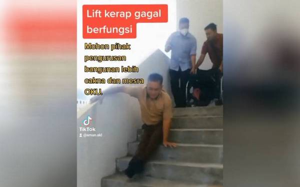 Tangkap layar video tular dalam aplikasi TikTok mengenai seorang lelaki OKU mengesot menuruni anak tangga di bangunan Wisma Persekutuan pada Khamis.