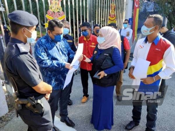 Nazilah (dua kanan) menyerahkan memorandum kepada Mohd Izzat (dua kiri) di hadapan pagar Bangunan SUK Selangor pada Khamis.