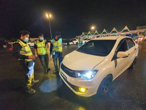 Anggota JPJ melakukan pemeriksaan terhadap kereta yang menggunakan lampu HID.