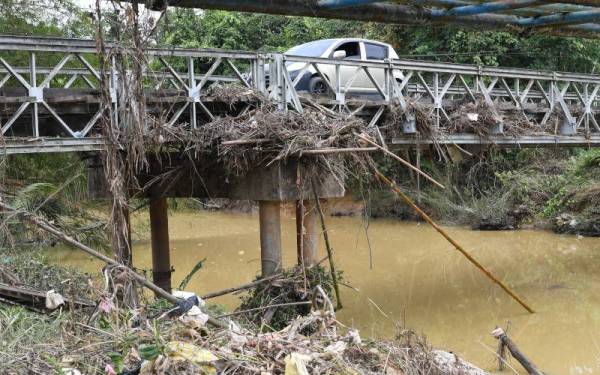 Ranting-ranting kayu yang tersangkut pada jambatan Sungai Kanibungan berikutan banjir besar melanda Kanibungan Pitas Ahad lepas. - Foto Bernama