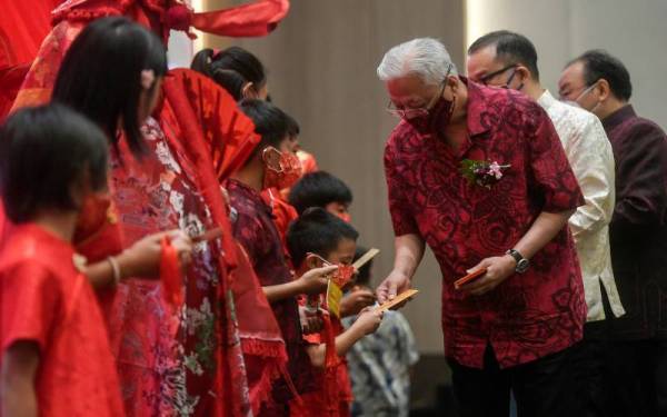 Ismail Sabri (tengah) memberi angpow kepada kanak-kanak dari Bodhi Homecare pada sambutan Tahun Baharu Cina anjuran Persatuan Rantaian Peruncitan dan Francais ASEAN (ARFF) pada Ahad. - Foto Bernama