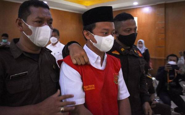 Herry Wiraman (tengah) dihadapkan di mahkamah daerah di Bandung, Jawa Barat. - AFP