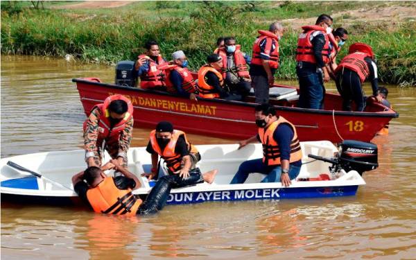 Rahmad Mariman (bot depan, kiri) menyertai demonstrasi menyelamat mangsa banjir selepas merasmikan Taklimat dan Latihan Pengendalian Bot serta Teknik Menyelamat Mangsa Banjir Dewan Undangan Negeri (DUN) Ayer Molek di sini pada Sabtu. - Foto Bernama 