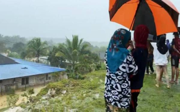 Mangsa banjir berlindung di pusat pemindahan sementara (PPS) di Kampung Gunung Menerong dan Kampung Menerong dekat Kuala Berang, Hulu Terengganu, di sini terpaksa memanjat bukit berhampiran selepas PPS itu dinaiki air.