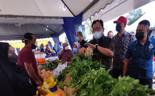 Eddin Syazlee (tiga dari kanan) melihat sayur-sayuran yang dijual di Program Jualan Keluarga di Dataran Melang di Kuala Pilah.