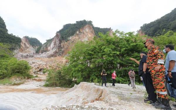 Mior Faridalathrash dan Azmi meninjau lokasi kejadian runtuhan batu kuari di Simpang Pulai.