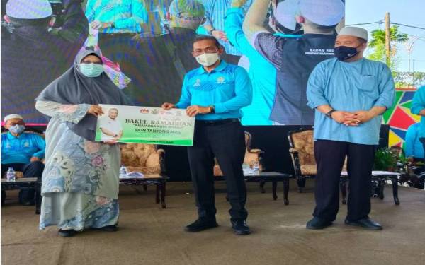 Takiyuddin (dua dari kanan) menyerahkan sumbangan kepada ADUN Tanjong Mas, Rohani Ibrahim sempena Bakul Makanan Bulan Ramadan pada Hari Keluarga Malaysia Peringkat Parlimen Kota Bharu, pada Ahad.