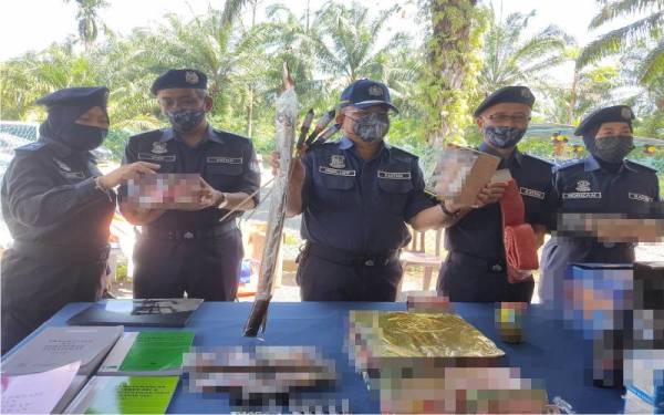 Abdul Latif (tengah) menunjukkan antara mercun yang dirampas Kastam semasa Program Khidmat Bakti Masyarakat (CSR) Kastam Zon Tengah Unit II di Kampung Orang Asli Bukit Tadom, Kuala Langat, pada Jumaat.