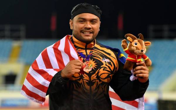 Atlet lontar peluru negara Muhammad Ziyad Zolkefli bersama pingat gangsa yang dimenanginya dalam acara lontar peluru pada Sukan SEA ke-31 di My Dinh National Stadium, Hanoi. - Foto Bernama