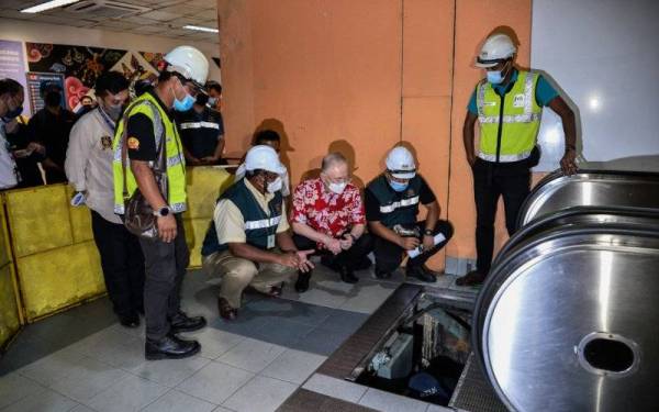 Ka Siong (tiga, kanan) melihat kerja-kerja menyelenggara ketika lawatan dan pemeriksaan mengenai kerosakan penggunaan eskalator di LRT Ampang Park pada Ahad. - Foto Bernama