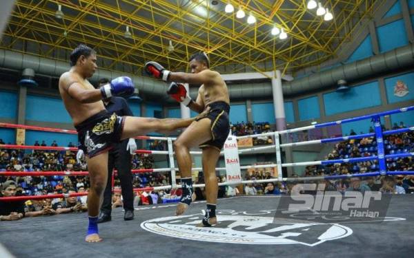 Muhammad Rafi (kanan) menepis asakan Prachit pada aksi Superfight lima pusingan di kejohanan muay Thai berkenaan. - Foto Sinar Harian ASRIL ASWANDI SHUKOR