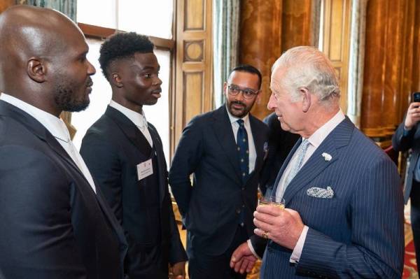 Putera Charles bertanyakan sesuatu kepada Saka di Istana Buckingham.