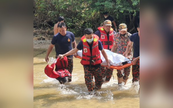 Anggota bomba mengangkat mayat seorang remaja lelaki yang lemas di Sungai Lagong, Selayang pada Jumaat.