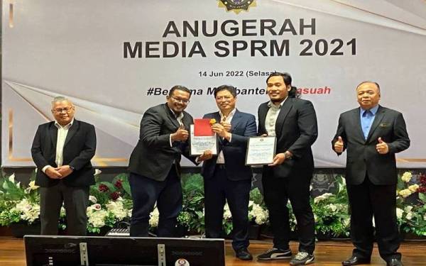 Wartawan Sinar Harian, Mohamad Hisyamuddin Ayub (dua, kiri) dan Muhammad Afham Ramli (dua, kanan) menerima anugerah juri kategori media cetak SPRM 2021 di Putrajaya, pada Selasa.