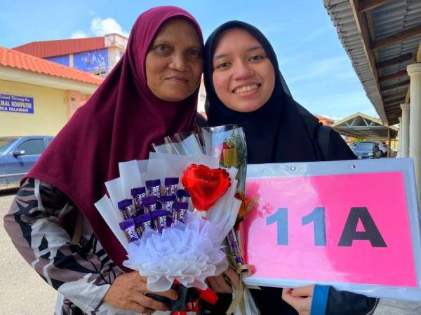 Umi Aida berkongsi kegembiraannya memperolehi keputusan 11A SPM 2021 bersama ibu yang hadir ke SMKA Falahiah pada Khamis.