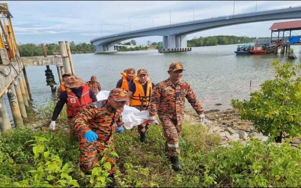 Anggota bomba membantu membawa mayat mangsa yang ditemui terapung di Sungai Kuantan berhampiran sebuah kilang ais di sini sebelum diserahkan kepada pihak polis untuk tindakan lanjut pada Khamis.