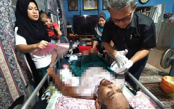 Maya Suriani melihat doktor persendirian, Dr Roslan Mohd Yunus menyapu ubat pada badan suaminya.