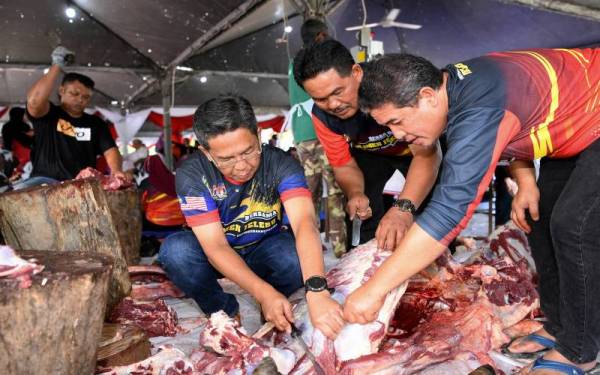 Timbalan Menteri Wilayah Persekutuan yang juga Ahli Parlimen Jelebu, Datuk Seri Jalaluddin Alias (dua, kiri) turut sama membantu memotong daging korban bersama penduduk pada program Korban Parlimen Jelebu yang diadakan di Bangunan UMNO Simpang Pertang, pada Rabu. - Foto Bernama
