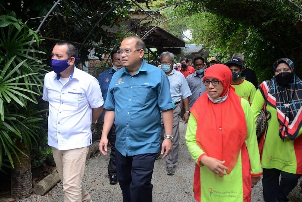 Ahmad Amzad (dua, kiri) melakukan lawatan kerja ke Min House Camp bagi meninjau inovasi sistem tanaman akuaponik oleh Persatuan Sindrom Down Negeri Kelantan pada Jumaat. -Foto Bernama