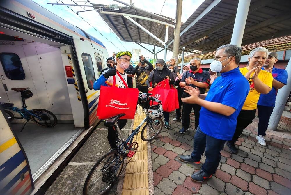 Mohd Zain (tengah) dan Masri (berbaju biru) menyambut kumpulan berbasikal dari Kuala Lumpur.