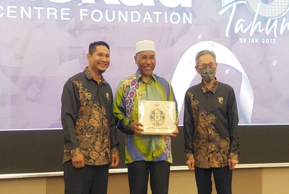 Idris bergambar bersama cenderamata yang diterima bersama Muhamad Fuad Yeoh (kanan) dan Muhammad Fakharuddin (kiri).