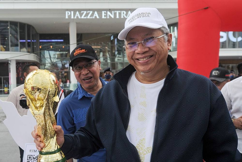 Menteri Komunikasi dan Multimedia Tan Sri Annuar Musa (kanan) menunjukkan replika Piala Dunia ketika hadir ke Majlis Pelancaran Menjelang Sepak Mula Piala Dunia Fifa Qatar 2022 di Piazza Pavillion Bukit Jalil. - Foto Bernama.