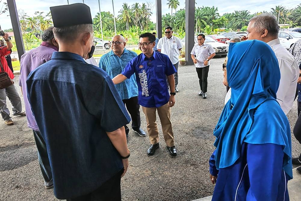 Mohamad (tengah) beramah mesra dengan mereka yang hadir pada Majlis Penyerahan Kunci Bangunan Baharu SMA Chuah.